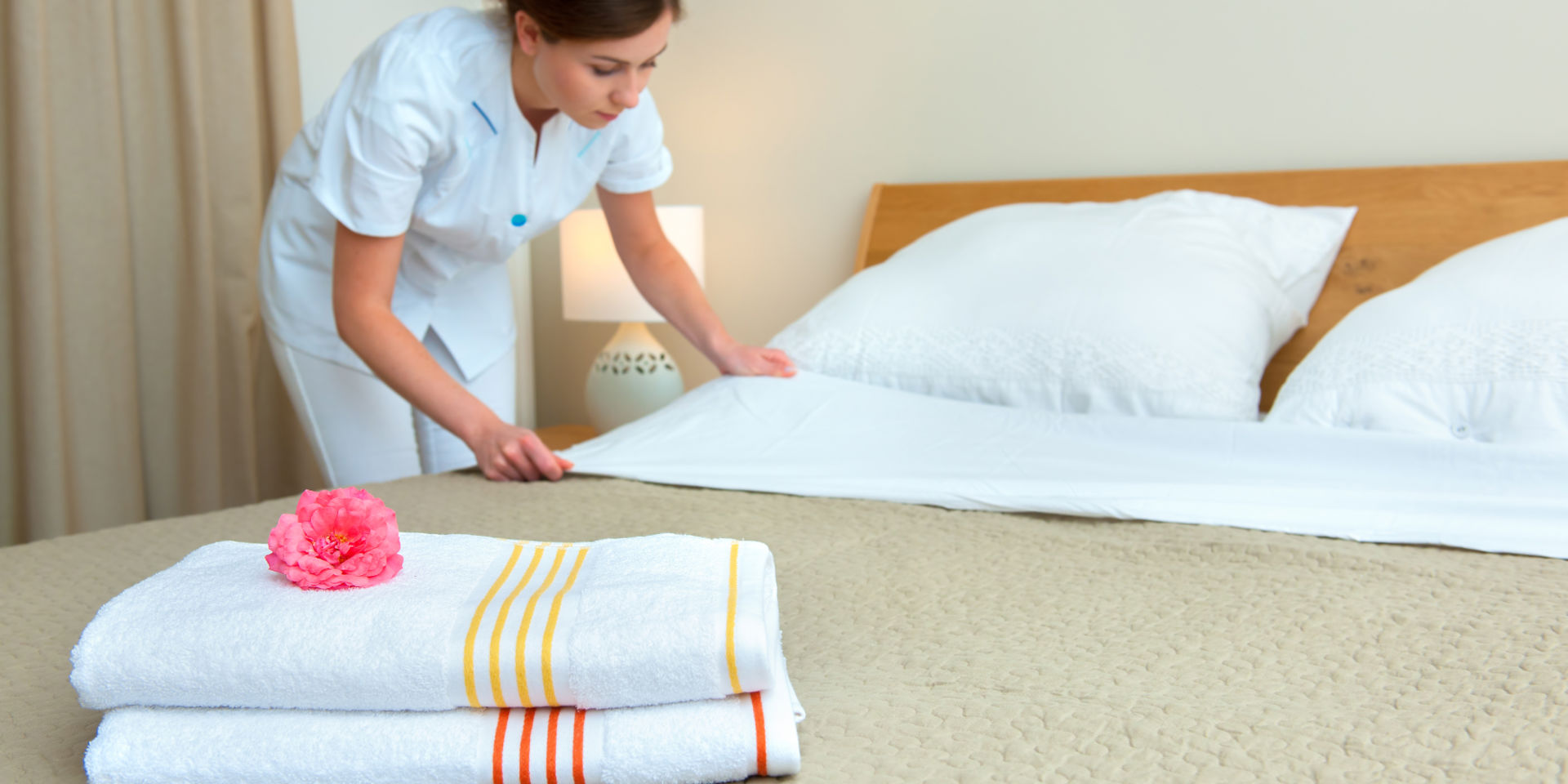 hotel staff making the bed